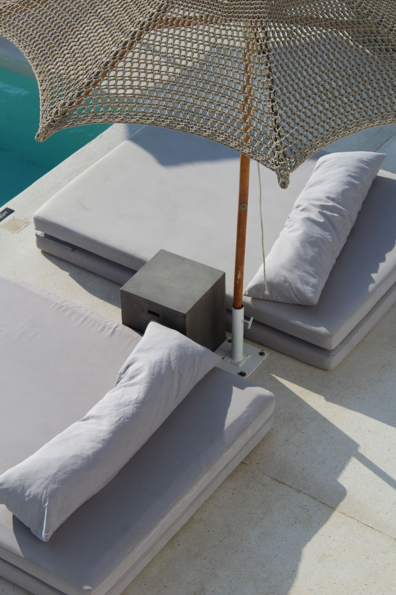 Koukoumi Vegan Hotel sunbeds and umbrella