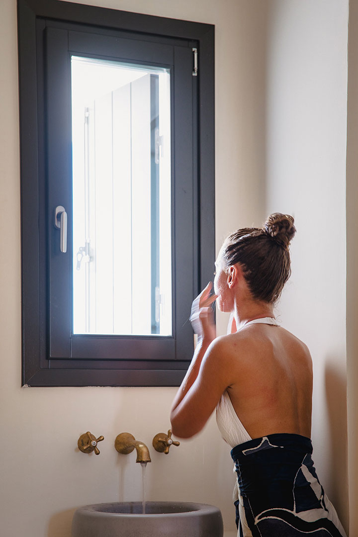 Koukoumi Vegan Hotel deluxe suite visitor using the sink