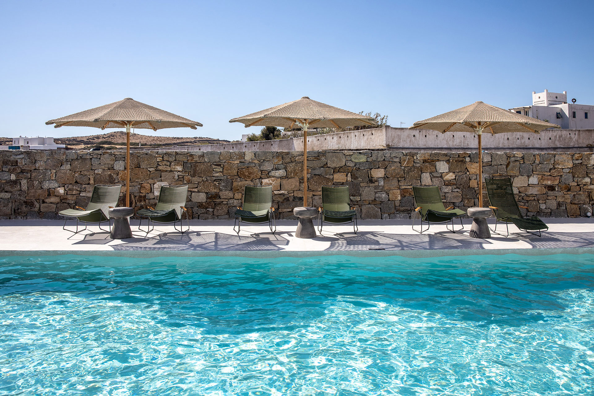 Koukoumi Vegan Hotel pool sunbeds and umbrellas